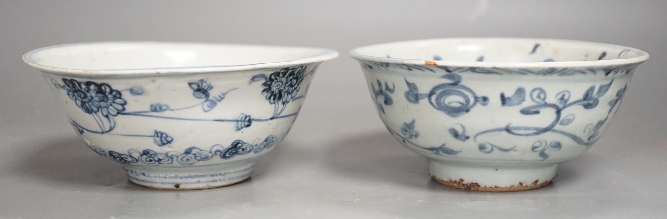 Two Chinese late Ming blue and white bowls, 16th/17th century, painted with flowers and foliage, 14.3 and 15.8cm